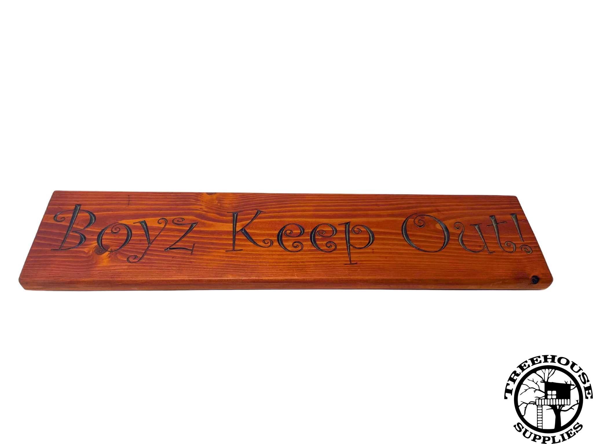 Two-foot long wooden sign with lettering with chestnut stain. engraved or carved text states Boyz Keep Out. Side view